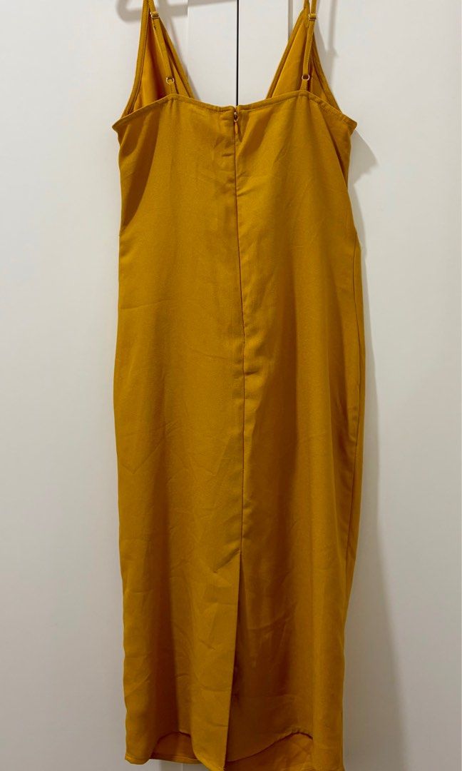 Forever 21 Mustard Midi Dress (Category: Dresses) located in Quezon City. Submitted by jamieeelaaa (Listing ID 1416177579, Image 2). Description: - Forever 21 mustard midi dress - Size: S/P - Design: Twisted knot front detail - Straps: Adjustable spaghetti straps - Neckline: V-neck - Closure: Back zipper - Origin: Made in Vietnam.