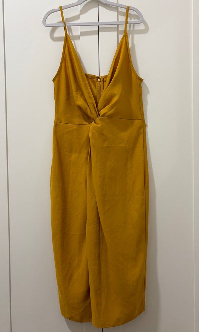 Forever 21 Mustard Midi Dress (Category: Dresses) located in Quezon City. Submitted by jamieeelaaa (Listing ID 1416177579, Image 1). Description: - Forever 21 mustard midi dress - Size: S/P - Design: Twisted knot front detail - Straps: Adjustable spaghetti straps - Neckline: V-neck - Closure: Back zipper - Origin: Made in Vietnam.