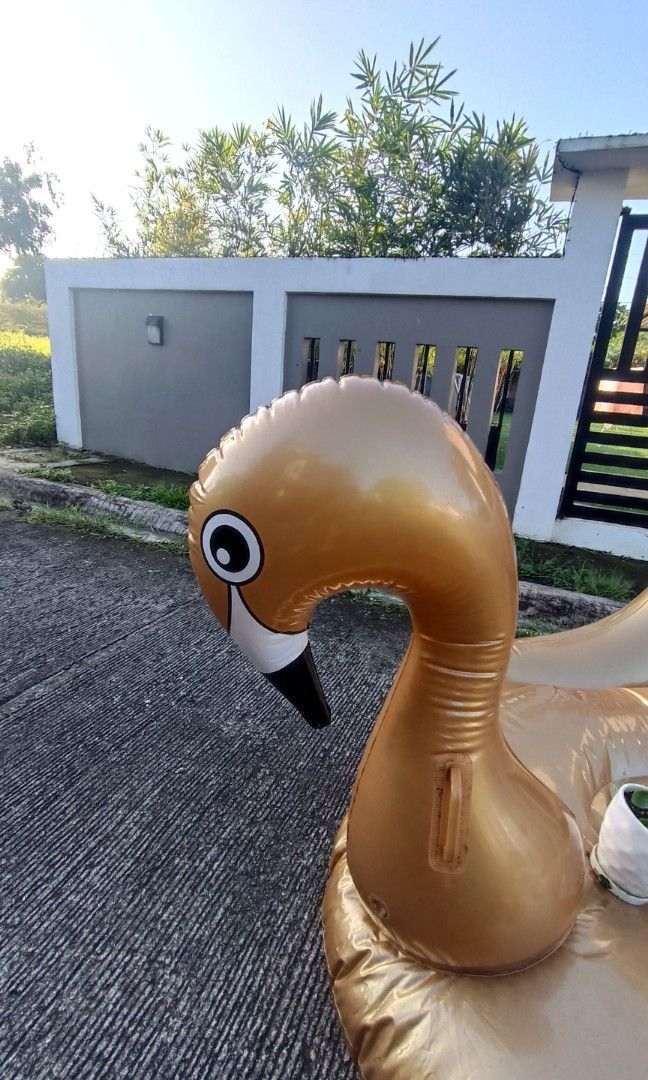 Giant inflatable gold swan pool floater (Category: Water Sports) located in Dasmarinas. Submitted by solstice.style (Listing ID 1416159748, Image 3). Description: This is a giant inflatable gold swan pool float. It is designed for use in pools, beaches, or lakes. It is made of durable, eco-friendly PVC vinyl material RFS decluttering.