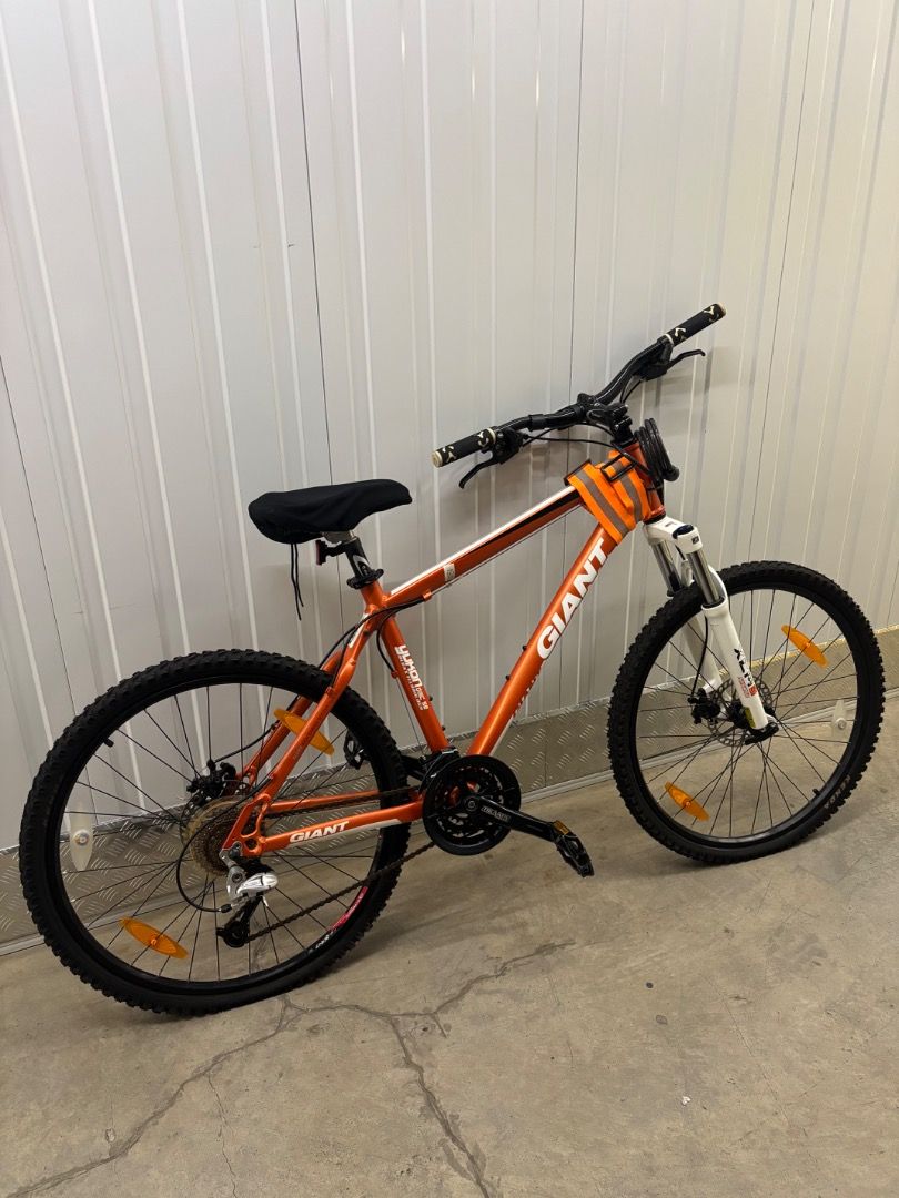 Giant Mountain Bike (Category: Bicycles) located in Taguig. Submitted by vibechic_thriftstore (Listing ID 1416147456, Image 1). Description: - Giant mountain bike - Front suspension - Disc brakes - Black seat - Wheel reflectors - Black handlebar - Giant logo on frame - Very good and working condition.