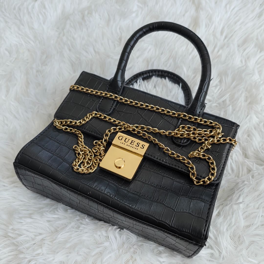 GUESS Sophie Mini Tote Bag (Category: Luxury Bags & Wallets) located in Calamba. Submitted by mreonal (Listing ID 1416136373, Image 2). Description: ✨ GUESS Sophie Mini Tote (DX22321) ✨ Chic black croc-embossed bag with gold hardware and chain strap. Perfect for everyday or special occasions. 💼✨ 🖤 Bought in the US, used only twice (still looks good as new!) 📦 Bag only (no box or dust bag) 🚚 Free shipping nationwide 𝗠𝗢𝗣: GCash/Maya/BPI/BDO 