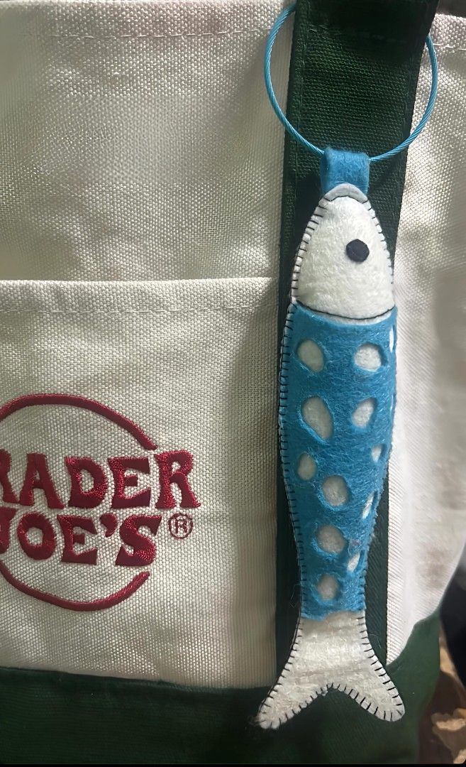 Handmade Felt Fish Bag Charm/ Keychain (Category: Plushies & Soft Toys) located in Mandaluyong City. Submitted by patchandpast (Listing ID 1416190010, Image 1). Description: Adorable handmade keychain/bag charm features a blue felt fish design. It has a white head and tail, with a blue body that has white cutouts. The keychain has a blue loop for easy attachment to keys or bags. It's a unique and charming accessory..