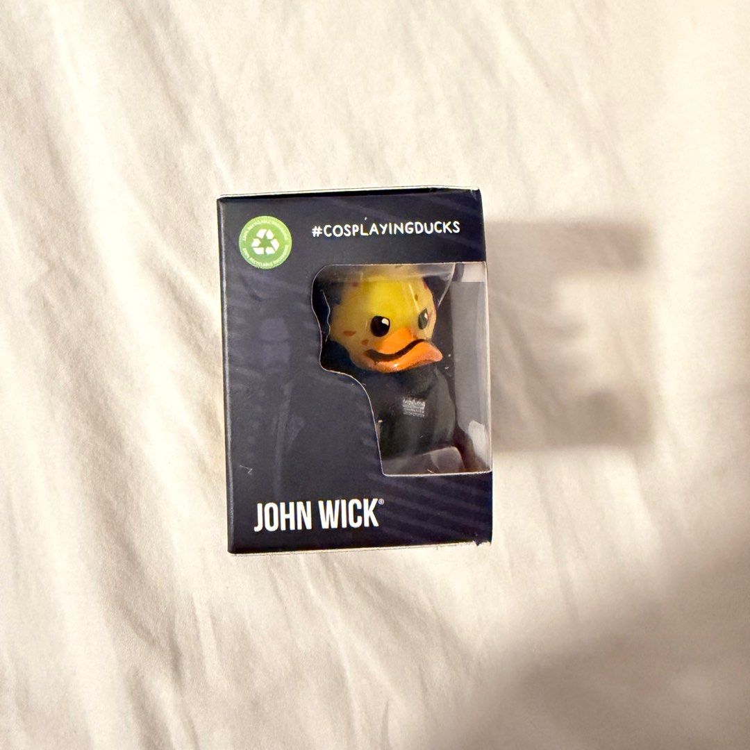 John Wick Tubbz Mini Cosplaying Duck (Category: Designer & Blind Box Toys) located in Quezon City. Submitted by gormbox (Listing ID 1416205380, Image 2). Description: - John Wick Tubbz Mini collectible figure. - Features John Wick as a duck with a pistol. - Comes in original packaging. - Packaging includes John Wick and Tubbz Mini logos. - Suitable for ages 3+. - Includes a QR code to view more Tubbz figures..