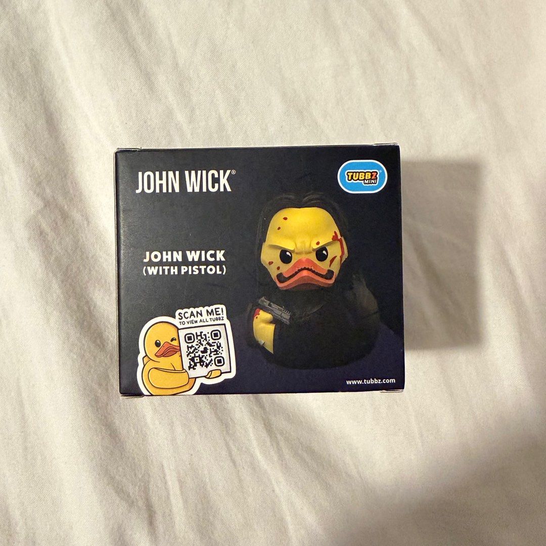 John Wick Tubbz Mini Cosplaying Duck (Category: Designer & Blind Box Toys) located in Quezon City. Submitted by gormbox (Listing ID 1416205380, Image 3). Description: - John Wick Tubbz Mini collectible figure. - Features John Wick as a duck with a pistol. - Comes in original packaging. - Packaging includes John Wick and Tubbz Mini logos. - Suitable for ages 3+. - Includes a QR code to view more Tubbz figures..
