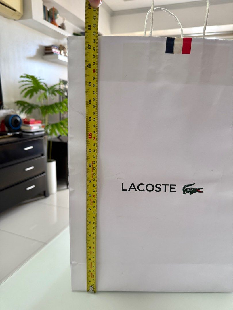 Lacoste XL Paper Bag (Category: Luxury Bags & Wallets) located in Manila. Submitted by the__store (Listing ID 1416174221, Image 2). Description: has minor damage and dort.