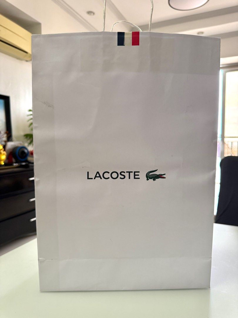 Lacoste XL Paper Bag (Category: Luxury Bags & Wallets) located in Manila. Submitted by the__store (Listing ID 1416174221, Image 1). Description: has minor damage and dort.