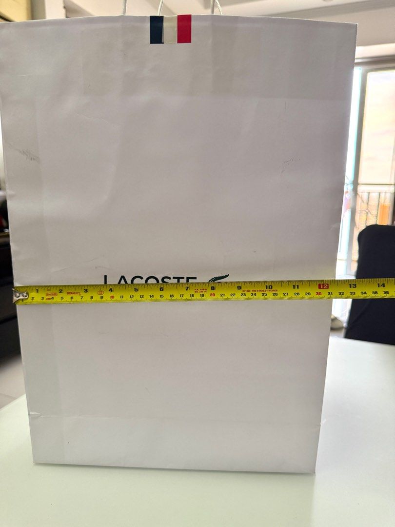 Lacoste XL Paper Bag (Category: Luxury Bags & Wallets) located in Manila. Submitted by the__store (Listing ID 1416174221, Image 3). Description: has minor damage and dort.