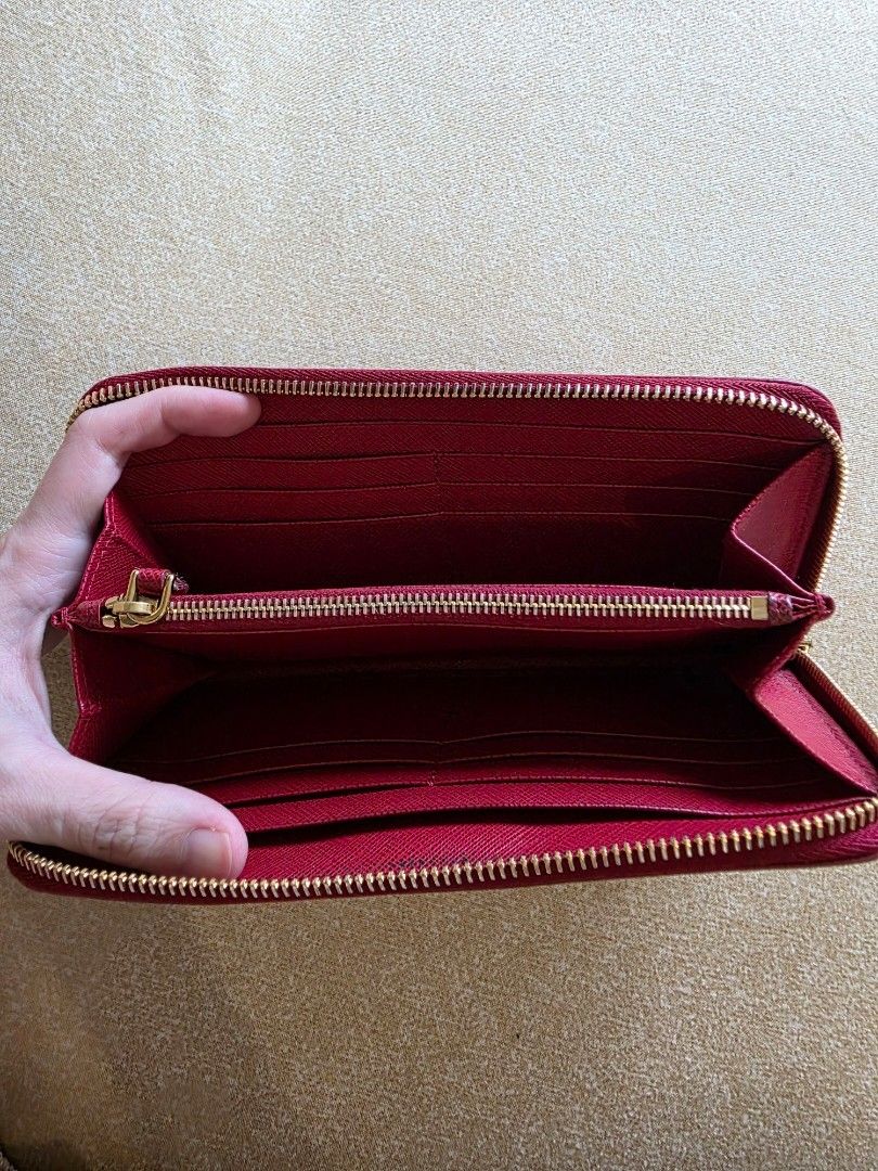 Original Prada Red Saffiano Leather Zip Long Wallet (Category: Wallets & Card holders) located in Makati City. Submitted by thisisanne (Listing ID 1416049151, Image 3). Description: Original Prada Red Saffiano Leather Zip Wallet Selling for Php9999 In very good condition Decluttering PM for inquiries Shipping fee c/o buyer Meet up Makati.