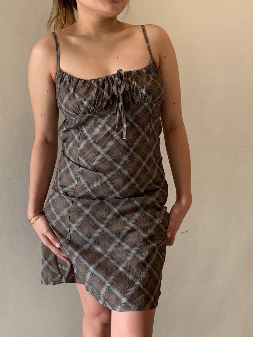 Plaid Mini Dress (Category: Dresses) located in Cebu City. Submitted by declutter_ysh (Listing ID 1416116528, Image 2). Description: - Plaid mini dress in brown and white - Gathered bust with tie detail - Spaghetti straps - Fitted bodice - Flared skirt - Ideal for casual and summer wear.