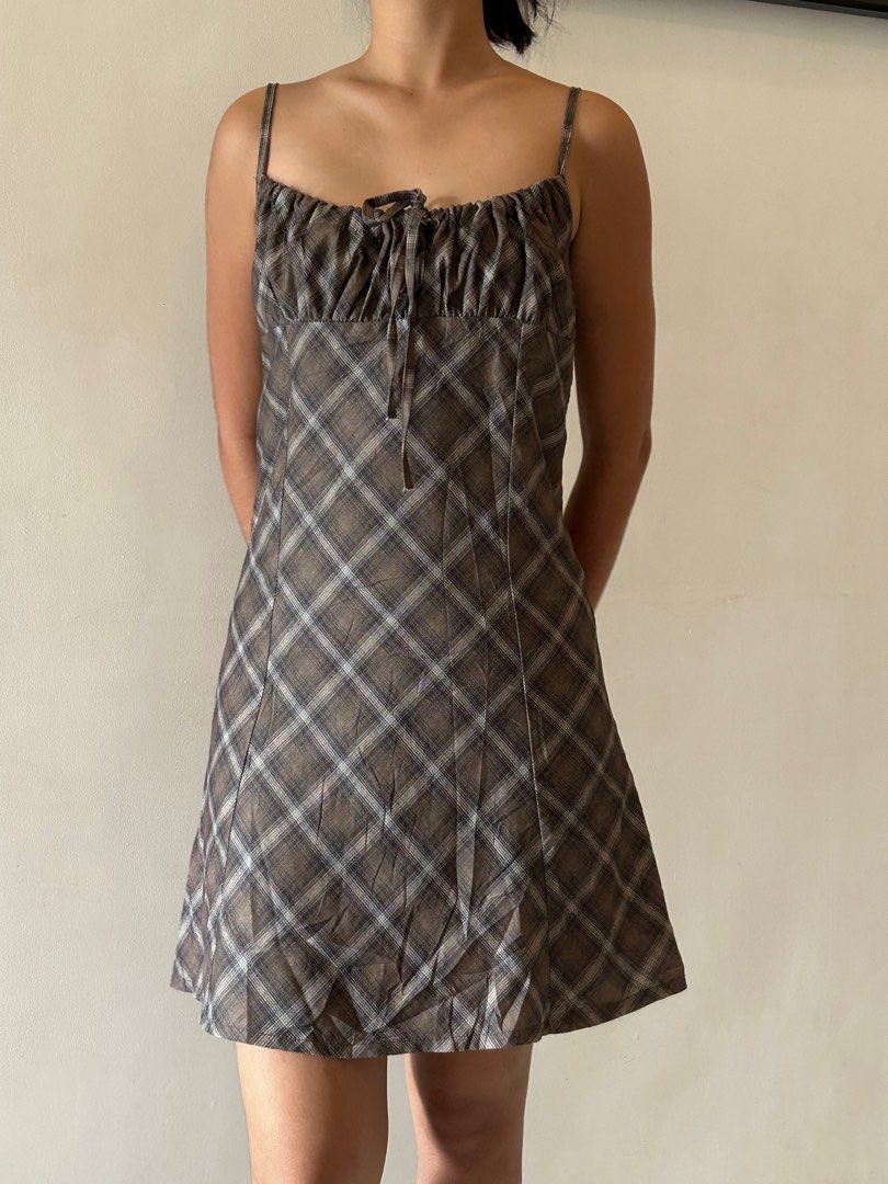 Plaid Mini Dress (Category: Dresses) located in Cebu City. Submitted by declutter_ysh (Listing ID 1416116528, Image 1). Description: - Plaid mini dress in brown and white - Gathered bust with tie detail - Spaghetti straps - Fitted bodice - Flared skirt - Ideal for casual and summer wear.