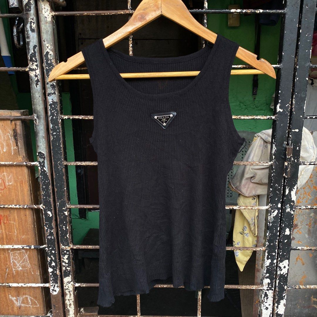 Prada Black Ribbed Tank Top (Category: Luxury Apparel) located in Manila. Submitted by d____g (Listing ID 1416010625, Image 1). Description: - Prada ribbed tank top - Features a Prada logo patch - Scoop neckline - Fitted silhouette - Sleeveless design - Versatile basic.