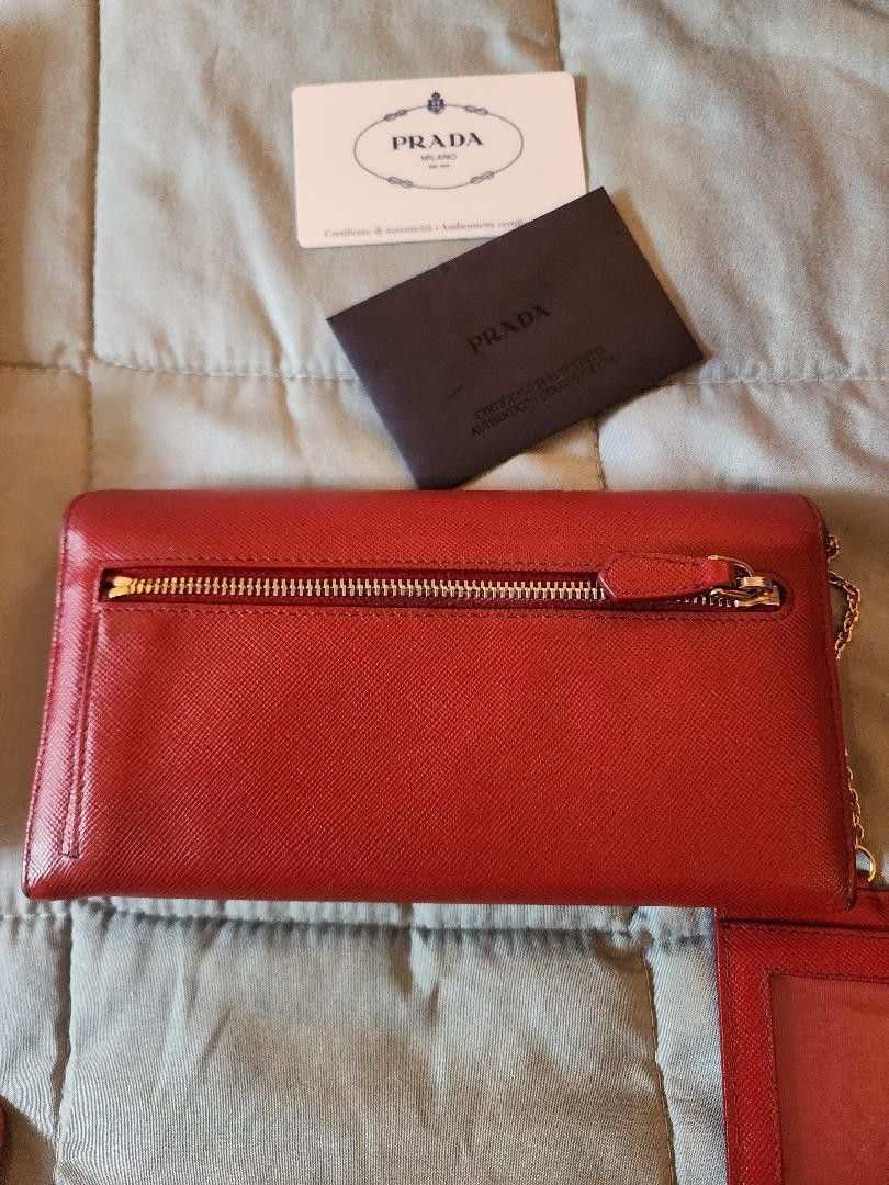 Prada Red Wallet with Card Holder (Category: Luxury Bags & Wallets) located in Pasay City. Submitted by 22spc (Listing ID 1416145996, Image 3). Description: - Authentic Prada red wallet and card holder - Includes original box, dust bag, and authenticity cards - Wallet features snap closure and gold Prada logo - Card holder with a simple design With free gift, coach perfume miniature set.