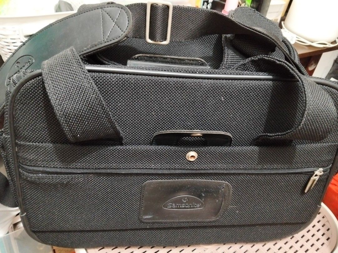 Samsonite Black Travel Bag (Category: Briefcases) located in Imus. Submitted by maggie.dewdrop (Listing ID 1416060718, Image 1). Description: - Durable black Samsonite travel bag - Main compartment with patterned lining - Zippered pocket inside - Detachable shoulder strap - Multiple zippered compartments - Top handle - Front pocket with snap closure - Samsonite logo visible RFS: Decluttering *needs cleaning; no damage *used only a few times, mata
