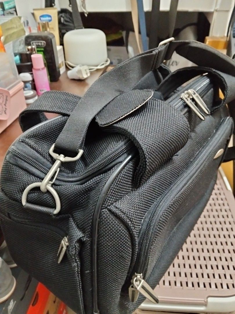 Samsonite Black Travel Bag (Category: Briefcases) located in Imus. Submitted by maggie.dewdrop (Listing ID 1416060718, Image 2). Description: - Durable black Samsonite travel bag - Main compartment with patterned lining - Zippered pocket inside - Detachable shoulder strap - Multiple zippered compartments - Top handle - Front pocket with snap closure - Samsonite logo visible RFS: Decluttering *needs cleaning; no damage *used only a few times, mata