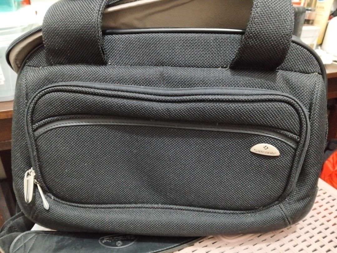 Samsonite Black Travel Bag (Category: Briefcases) located in Imus. Submitted by maggie.dewdrop (Listing ID 1416060718, Image 3). Description: - Durable black Samsonite travel bag - Main compartment with patterned lining - Zippered pocket inside - Detachable shoulder strap - Multiple zippered compartments - Top handle - Front pocket with snap closure - Samsonite logo visible RFS: Decluttering *needs cleaning; no damage *used only a few times, mata