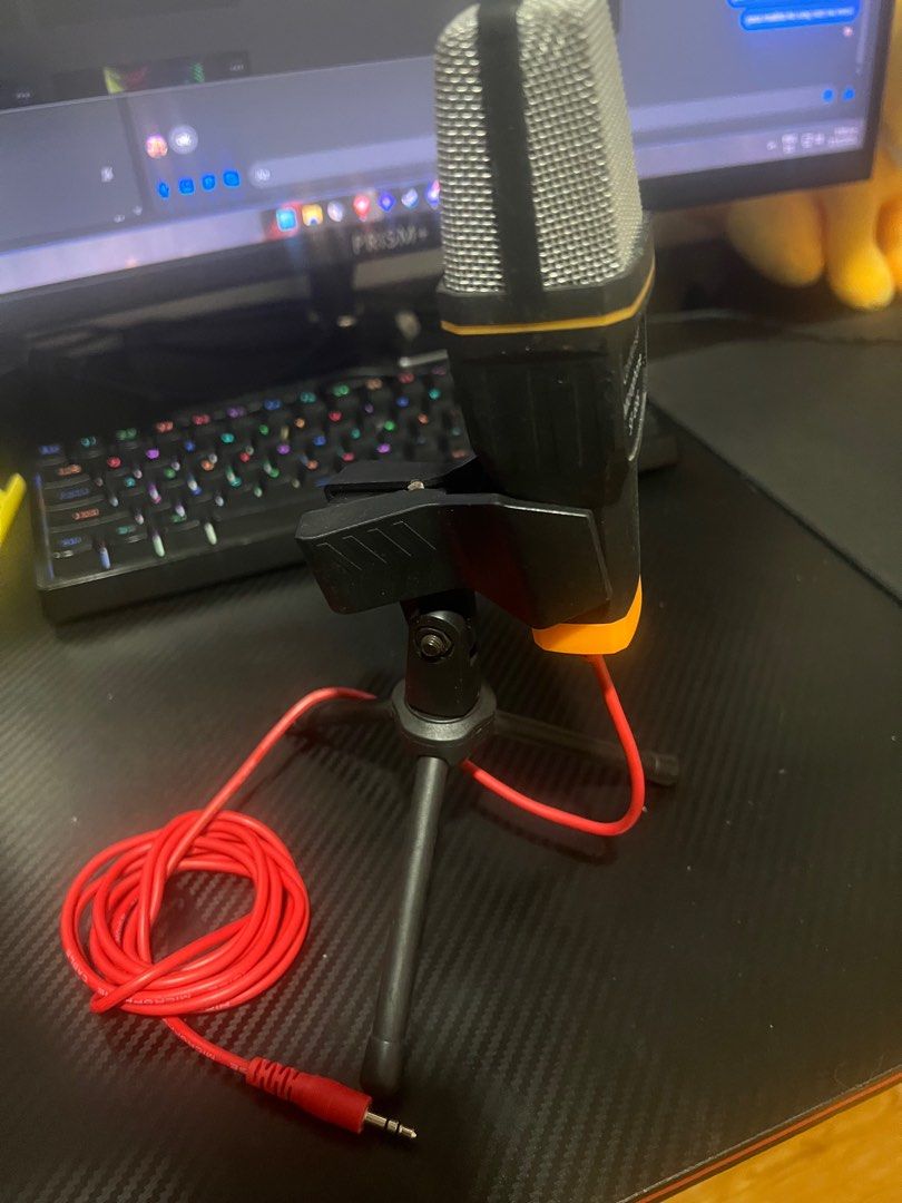 SF-666 Condenser Microphone with Tripod (Category: Microphones) located in Batangas. Submitted by louisalcayde1 (Listing ID 1416120032, Image 2). Description: - SF-666 Condenser Microphone - Includes mini tripod stand and red audio cable - Stylish black and orange design with silver mesh head - 3.5mm jack for easy connection - Ideal for streaming, podcasting, and vocal recording - Delivers clear audio quality.