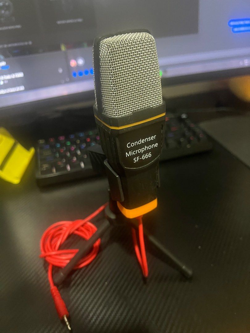 SF-666 Condenser Microphone with Tripod (Category: Microphones) located in Batangas. Submitted by louisalcayde1 (Listing ID 1416120032, Image 1). Description: - SF-666 Condenser Microphone - Includes mini tripod stand and red audio cable - Stylish black and orange design with silver mesh head - 3.5mm jack for easy connection - Ideal for streaming, podcasting, and vocal recording - Delivers clear audio quality.