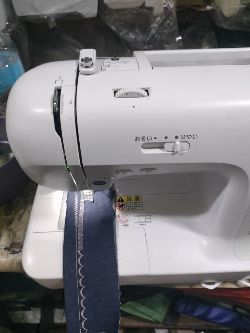 Singer Sewing Machine (Category: Craft Supplies & Tools) located in Manila. Submitted by faststone-c3c8 (Listing ID 1416211119, Image 3). Description: - White Singer sewing machine - Multiple stitch options - Adjustable stitch width and length - Includes a sample of sewn fabric - Suitable for various sewing projects - Singer logo visible.