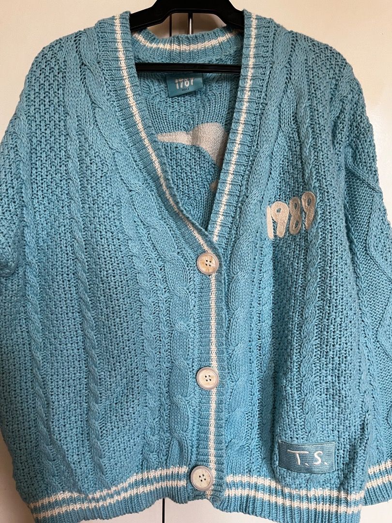 Taylor Swift 1989 Taylor's Version Cardigan (Category: Coats, Jackets and Outerwear) located in Manila. Submitted by simp4tsuki (Listing ID 1416025463, Image 1). Description: - Authentic Taylor Swift 1989 (Taylor's Version) cardigan - Light blue knit with white stripes - Features "1989" embroidery on the front - Size: MD/LG (tag indicates) - Condition: Good.
