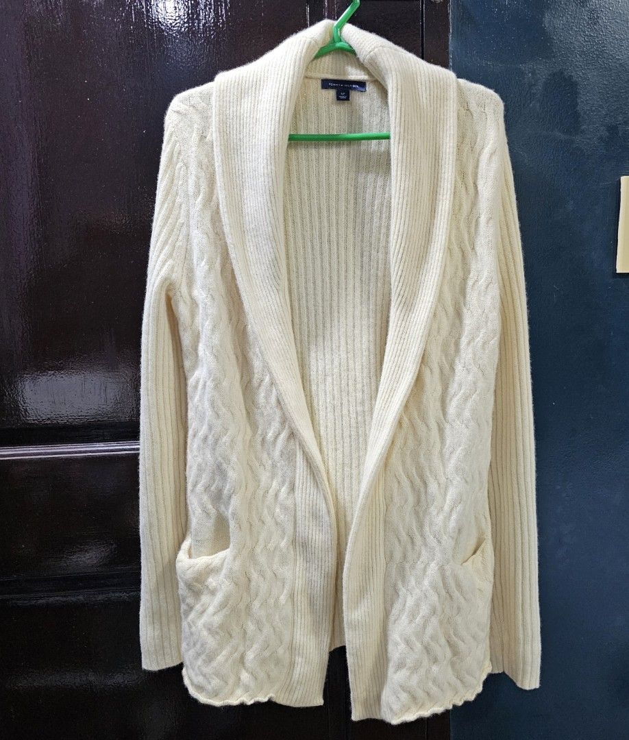 Tommy Hilfiger Cream Cardigan (Category: Coats, Jackets and Outerwear) located in Caloocan City. Submitted by e_o62059 (Listing ID 1416211079, Image 1). Description: Cream-colored Tommy Hilfiger cardigan. Features a shawl collar, two front pockets, and no buttons. Made in China. Size S/P. Sleeve length is 27 inches, shoulder width is 16 inches, and length is 28 inches. The cardigan has a textured design on the front pockets and sleeves. pristine 