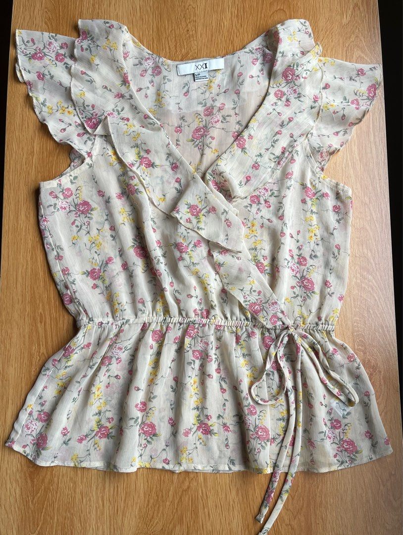 XXI Floral Wrap Blouse S/P (Category: Blouses) located in Santa Cruz. Submitted by lilpurpleseven (Listing ID 1416014983, Image 1). Description: - XXI floral wrap blouse - Size: S/P - Design: Wrap style with tie waist - Features: V-neckline, ruffled sleeves - Fabric: Light and flowy - Color: Cream background with pink and yellow floral pattern .