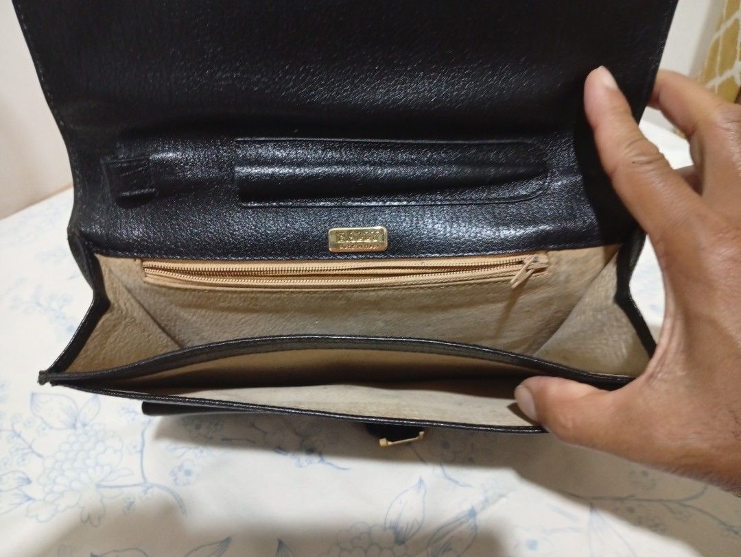 Bally Black Leather Clutch (Category: Luxury Bags & Wallets) located in Quezon City. Submitted by mcenon35 (Listing ID 1416364343, Image 3). Description: - Authentic Bally clutch - Black leather exterior - Gold-tone clasp - Gold Bally logo inside - Interior: Multiple compartments, zippered pocket, card slots, and snap closure pocket - Made in Italy.