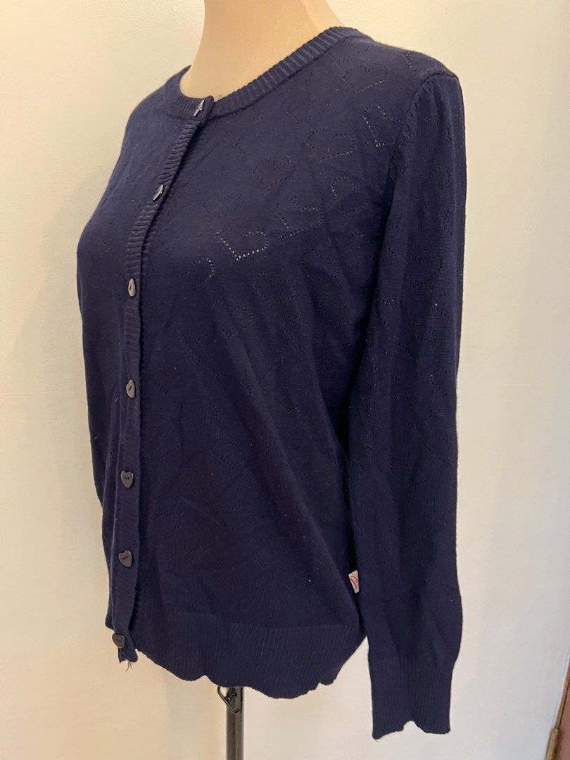 Bayo Navy Blue Cardigan (Category: Coats, Jackets and Outerwear) located in Quezon City. Submitted by annemargarethh (Listing ID 1416267248, Image 3). Description: - Love by Bayo navy blue cardigan - Size: L - Features a round neckline - Button-down closure - Adorned with heart-shaped cutouts and buttons - Great for layering - A versatile wardrobe essential.