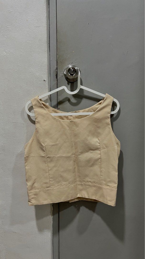 Beige Sleeveless Top (Category: Sleeveless) located in Taguig. Submitted by thriftieth (Listing ID 1416403192, Image 1). Description: - Beige sleeveless top - Round neckline - Button detail at back - Cropped length - Tailored fit - Smooth fabric ✅ negotiable.