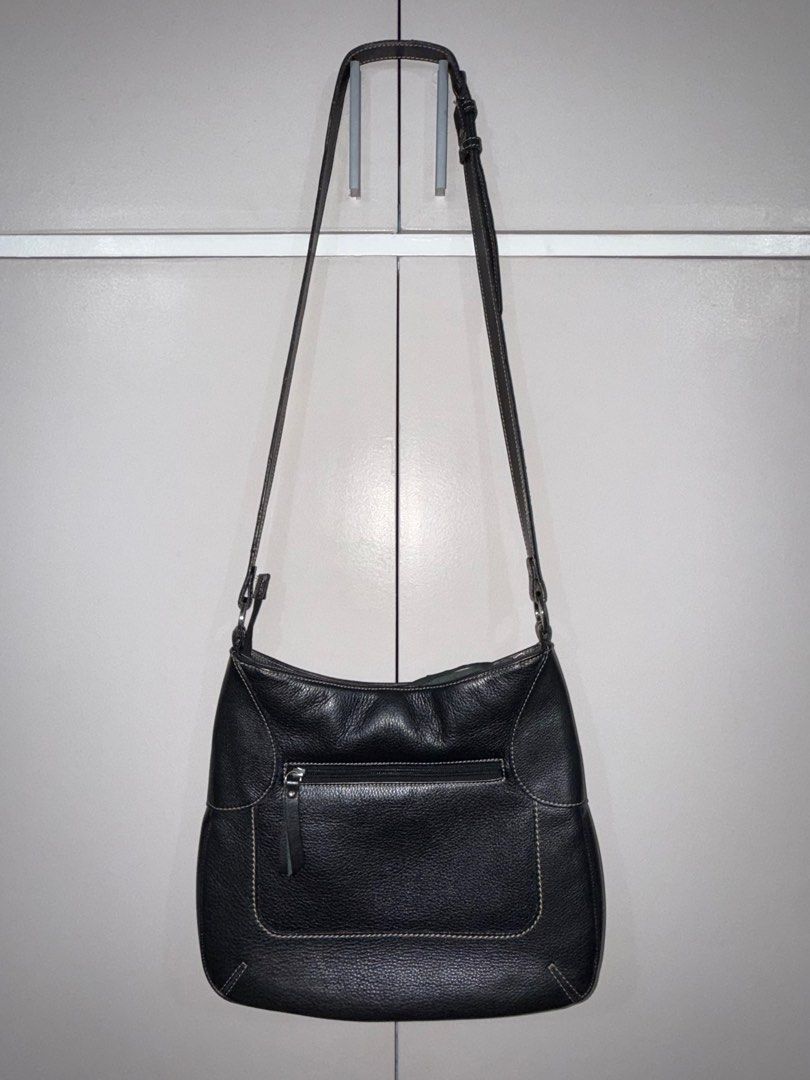 Black Leather Shoulder Bag (Category: Shoulder Bags) located in Quezon City. Submitted by ramearc (Listing ID 1416362571, Image 2). Description: - Black pebbled leather shoulder bag - Back zippered pocket - Adjustable long strap - Silver-toned hardware - Striped fabric lining - Multiple compartments inside - White stitching details - Inner lining needs cleaning - w/ minimal scuffs and signs of use on the strap.