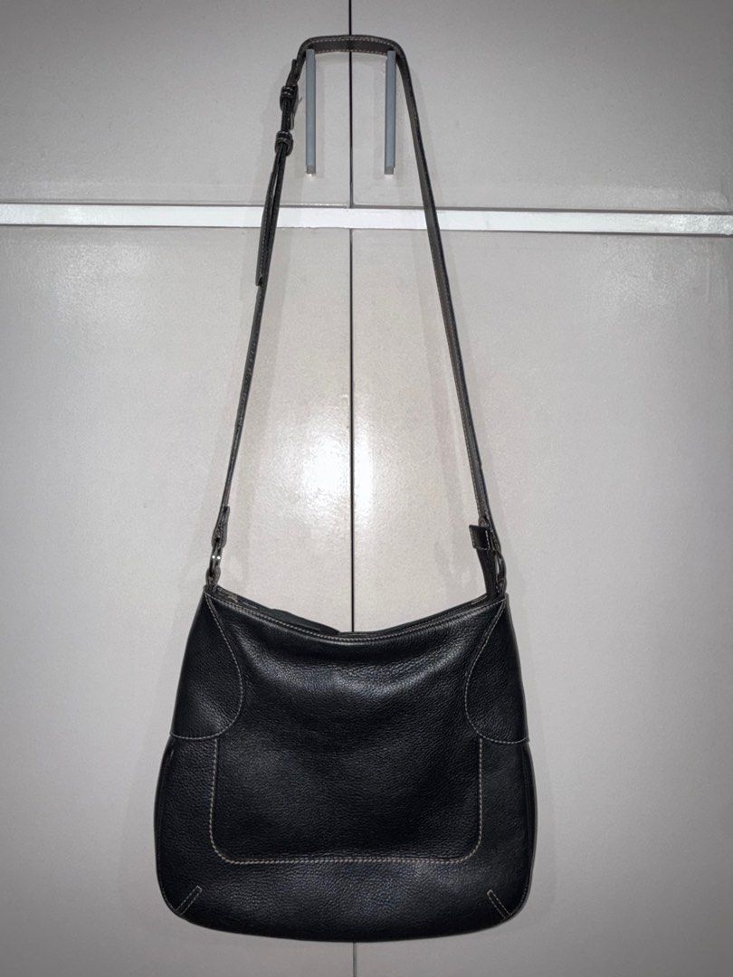 Black Leather Shoulder Bag (Category: Shoulder Bags) located in Quezon City. Submitted by ramearc (Listing ID 1416362571, Image 1). Description: - Black pebbled leather shoulder bag - Back zippered pocket - Adjustable long strap - Silver-toned hardware - Striped fabric lining - Multiple compartments inside - White stitching details - Inner lining needs cleaning - w/ minimal scuffs and signs of use on the strap.
