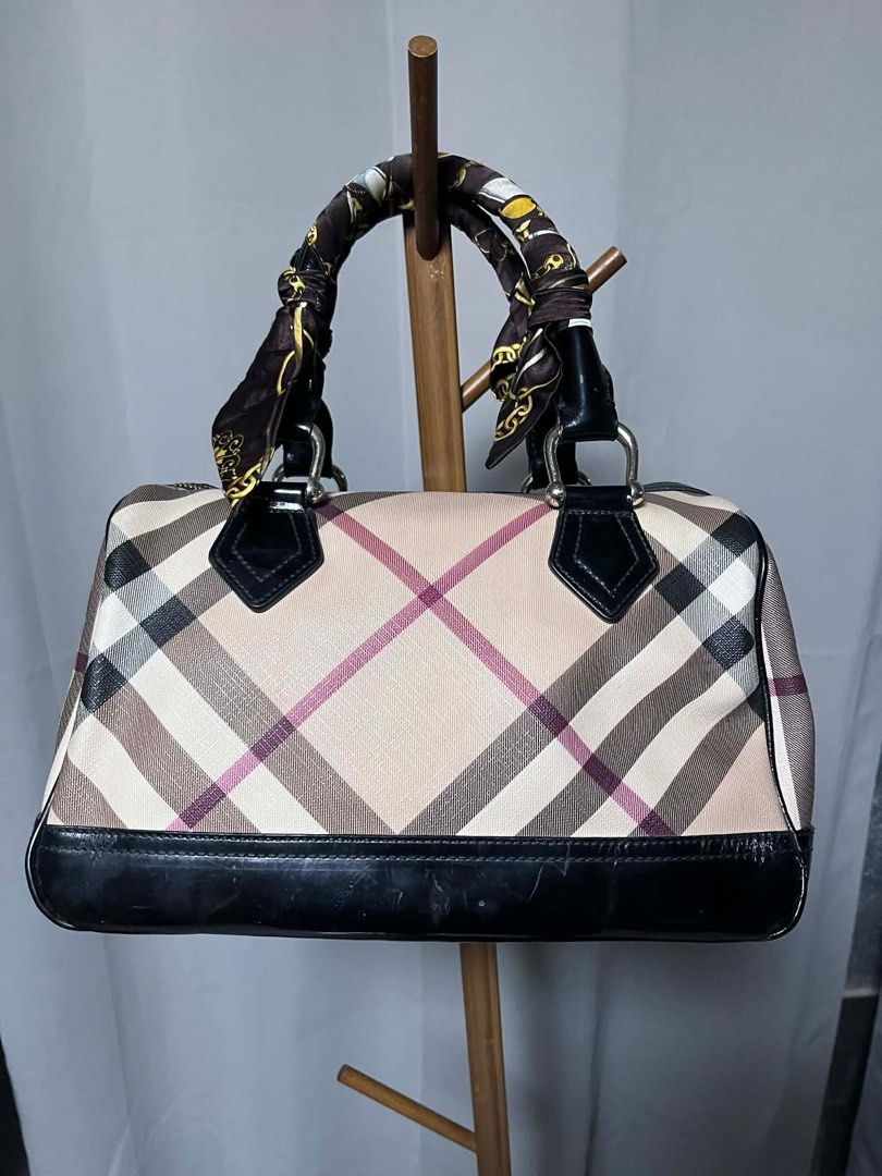 Burberry Nova Check Boston Bag (Category: Luxury Bags & Wallets) located in Quezon City. Submitted by carmeladelacruz82 (Listing ID 1416395080, Image 2). Description: - AUTHENTIC Burberry Nova Check Boston Bag - Material: Canvas and Leather - no dust bag or box - Condition: No major flaws - Issue: just has some scuffs on canvas and a bit of peeling sa ilalim ng bag (see last pictures).