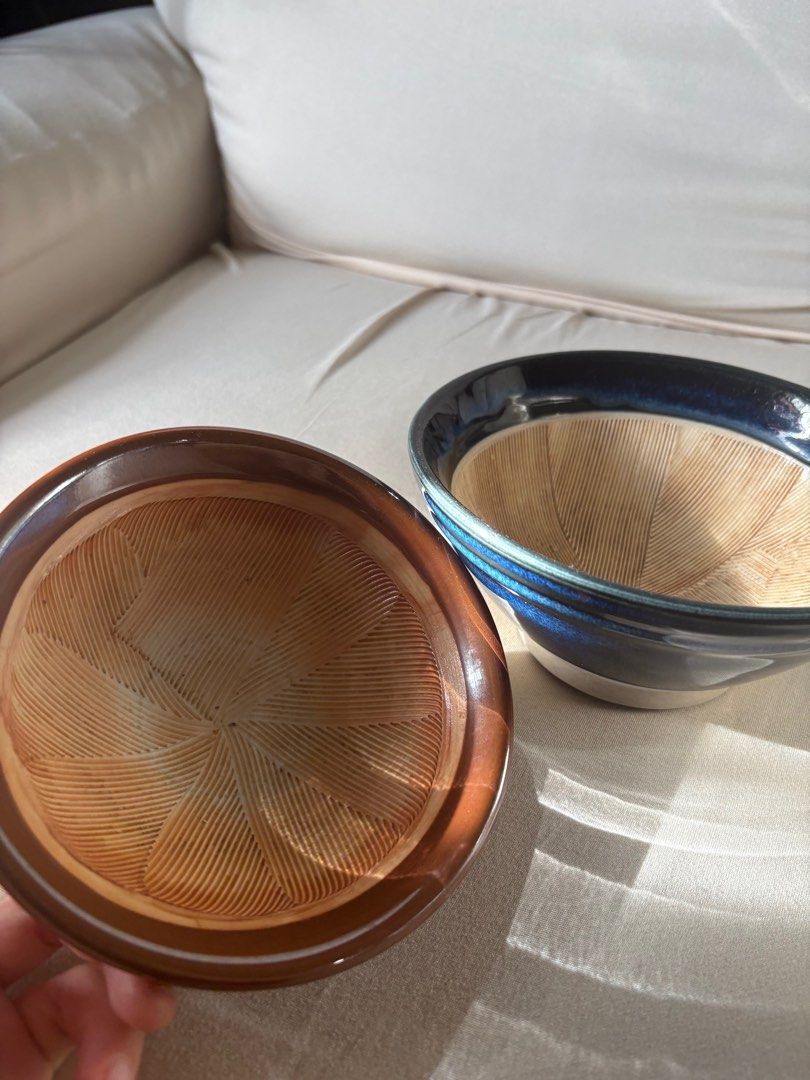 Ceramic Bowls (Category: Other Kitchenware & Tableware) located in Makati City. Submitted by the.saintly.club (Listing ID 1416299579, Image 1). Description: - Set includes two ceramic mortar and pestle bowls. - One bowl is brown. - The other is blue with a white base. - Both bowls have textured interiors. - Ideal for grinding spices and preparing ingredients..