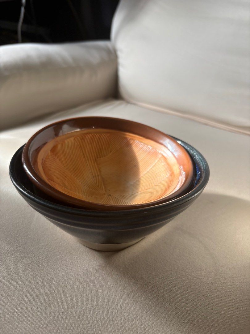 Ceramic Bowls (Category: Other Kitchenware & Tableware) located in Makati City. Submitted by the.saintly.club (Listing ID 1416299579, Image 3). Description: - Set includes two ceramic mortar and pestle bowls. - One bowl is brown. - The other is blue with a white base. - Both bowls have textured interiors. - Ideal for grinding spices and preparing ingredients..