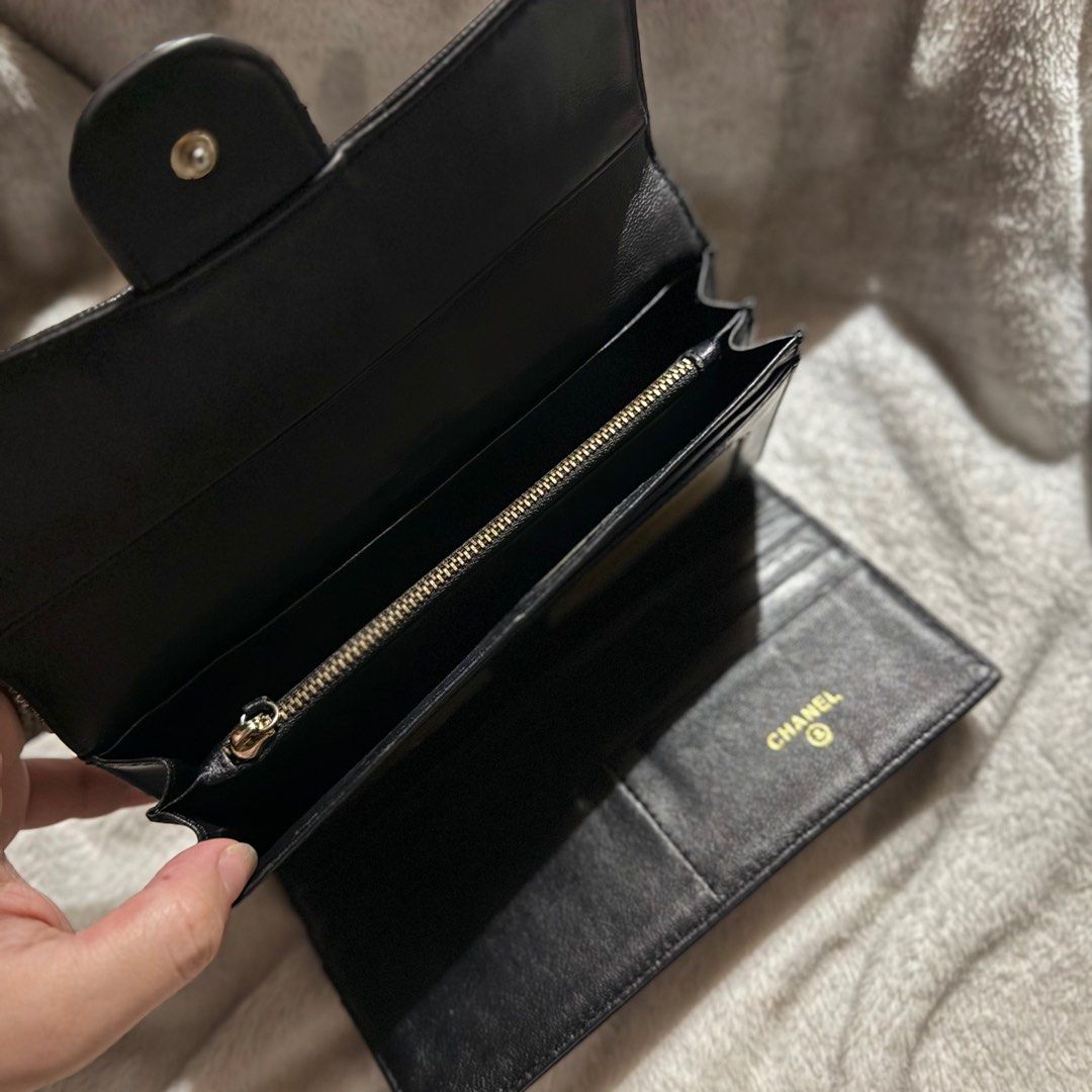 Chanel Camellia Embossed Wallet (Category: Luxury Bags & Wallets) located in Bulacan. Submitted by _snowyyy (Listing ID 1416401199, Image 3). Description: - Black leather wallet - Embossed camellia flower design - Flap closure with Chanel logo - Multiple card slots - Zippered compartment - Chanel logo inside.