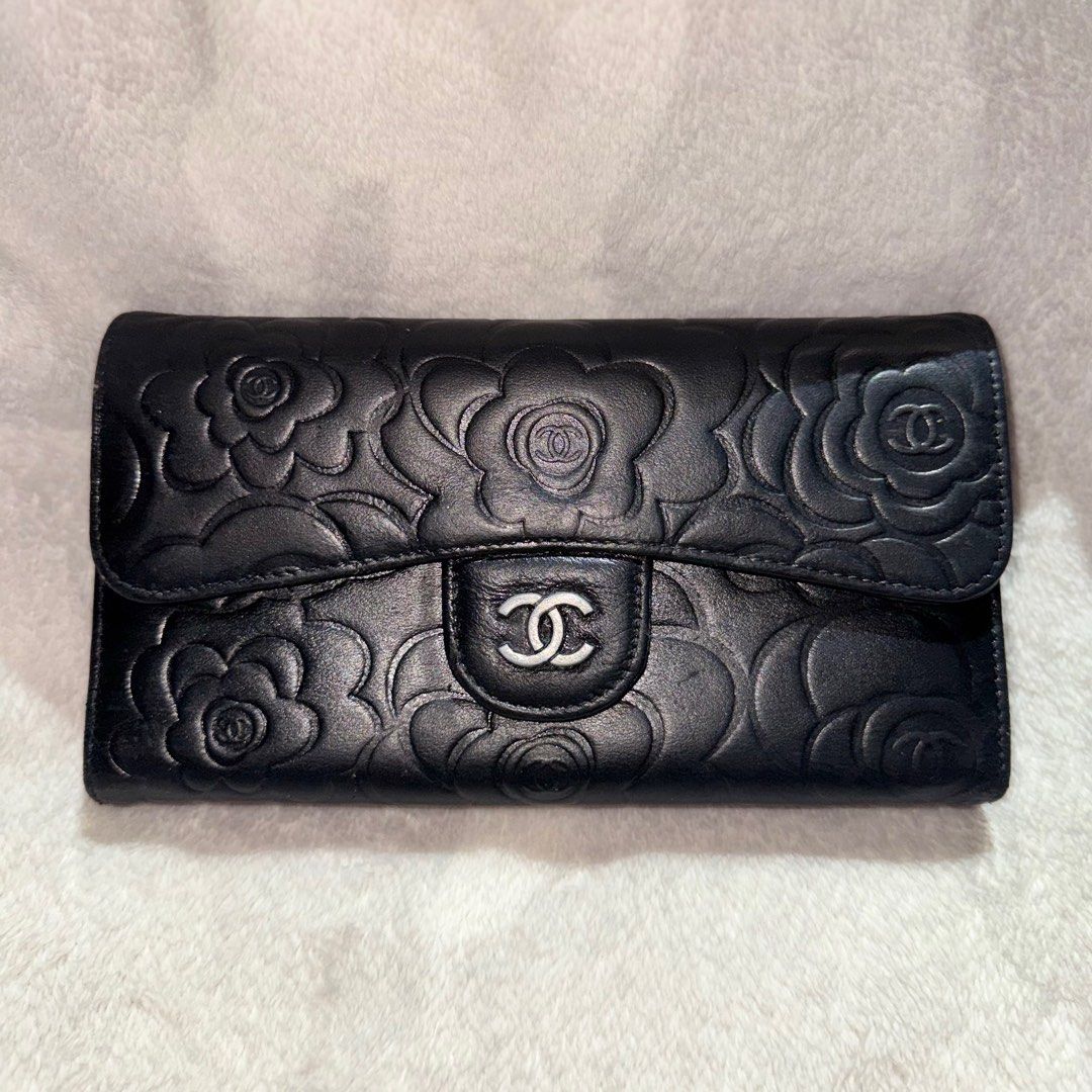 Chanel Camellia Embossed Wallet (Category: Luxury Bags & Wallets) located in Bulacan. Submitted by _snowyyy (Listing ID 1416401199, Image 1). Description: - Black leather wallet - Embossed camellia flower design - Flap closure with Chanel logo - Multiple card slots - Zippered compartment - Chanel logo inside.