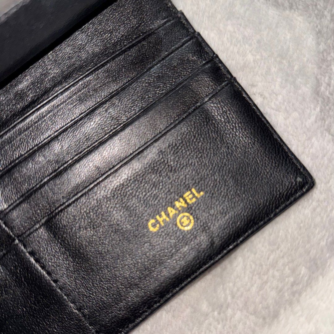 Chanel Camellia Embossed Wallet (Category: Luxury Bags & Wallets) located in Bulacan. Submitted by _snowyyy (Listing ID 1416401199, Image 2). Description: - Black leather wallet - Embossed camellia flower design - Flap closure with Chanel logo - Multiple card slots - Zippered compartment - Chanel logo inside.