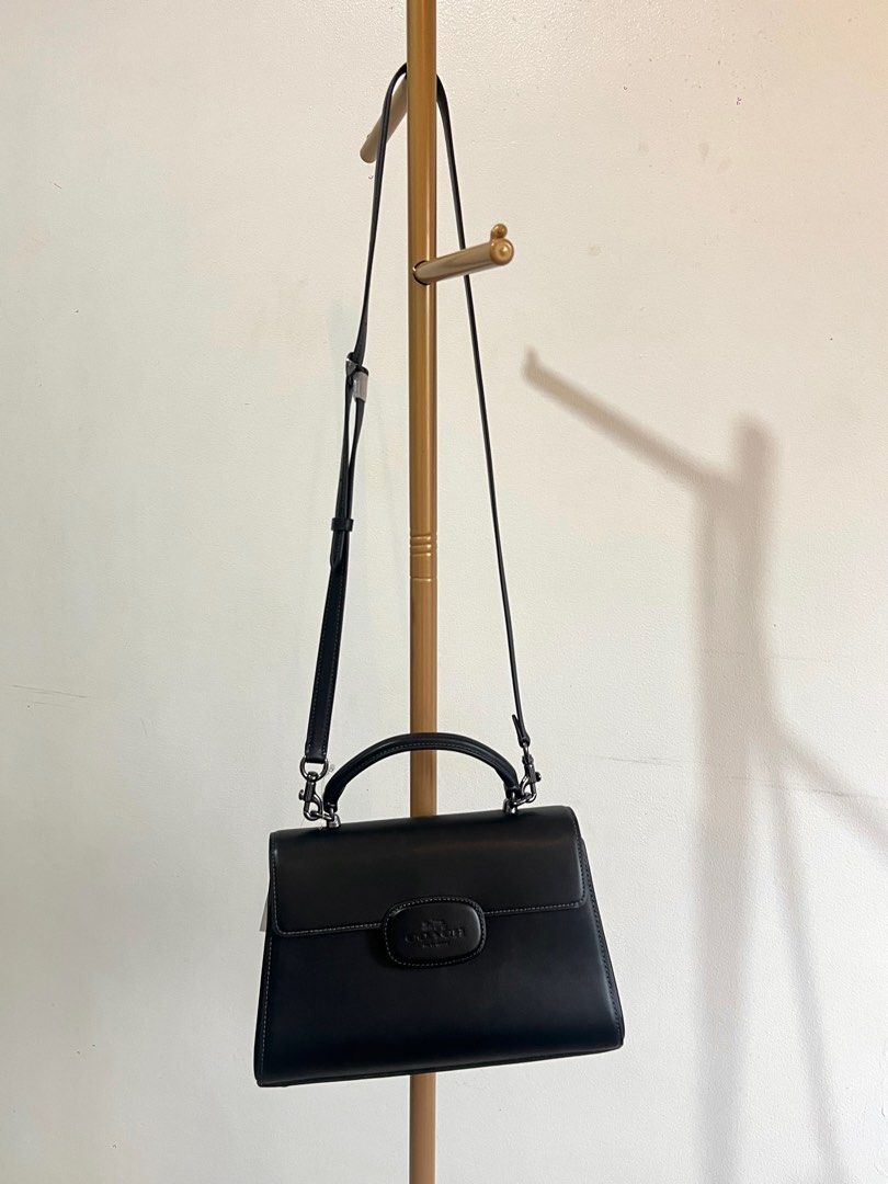 Coach Eliza Top Handle (Category: Luxury Bags & Wallets) located in Makati City. Submitted by audreyngoldilocks (Listing ID 1416405943, Image 2). Description: - Coach black leather handbag - Top handle and detachable shoulder strap - Flap closure with Coach logo detail - Interior zippered compartment - Includes original packaging - Suitable for various occasions.