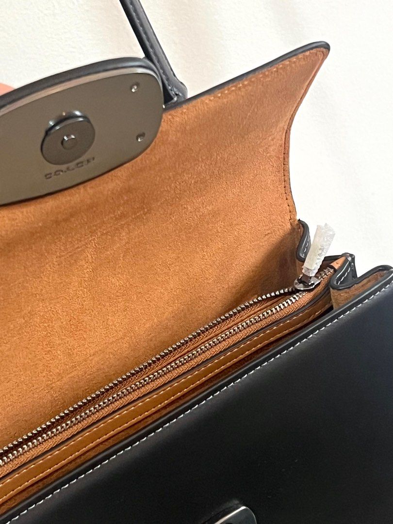 Coach Eliza Top Handle (Category: Luxury Bags & Wallets) located in Makati City. Submitted by audreyngoldilocks (Listing ID 1416405943, Image 3). Description: - Coach black leather handbag - Top handle and detachable shoulder strap - Flap closure with Coach logo detail - Interior zippered compartment - Includes original packaging - Suitable for various occasions.