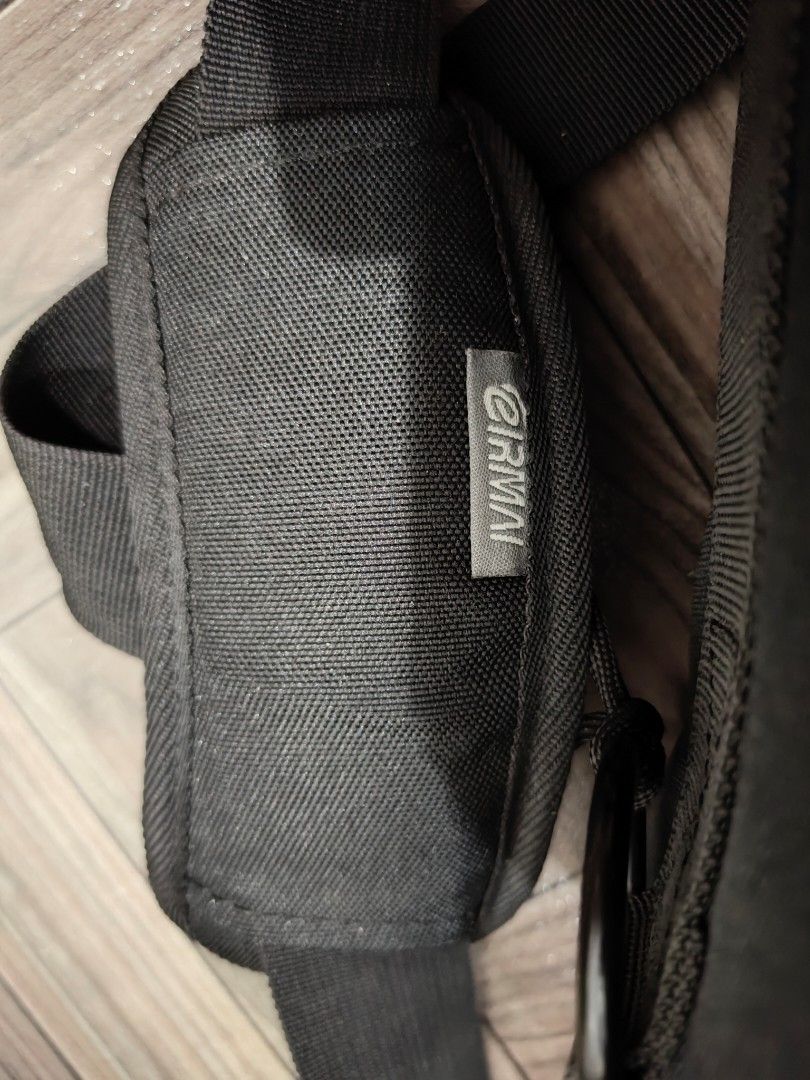 Eirmai Camera Bag (Category: Camera Bags & Carriers) located in Quezon City. Submitted by thriftstershop (Listing ID 1416406370, Image 2). Description: Eirrmai camera bag features multiple compartments and pockets for organizing camera gear. It has a padded shoulder strap for comfortable carrying. The bag has a black and gray color scheme with a zipper closure. The interior includes several padded dividers and pockets. The bag has a Eirmai logo o
