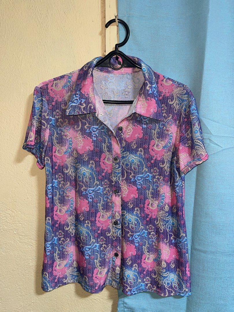 Floral Print Short Sleeve Blouse (Category: Blouses) located in Quezon City. Submitted by ___maris03 (Listing ID 1416403354, Image 1). Description: - Floral print in pink, blue, and purple - Short sleeves - Collared neckline - Button-down closure - Textured, ribbed fabric - Stylish for casual wear.