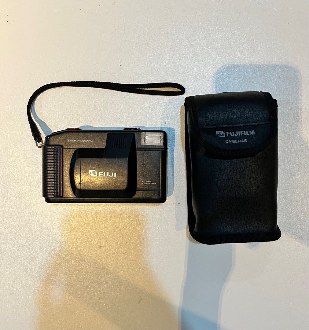 Fuji DL-10 Film Camera with Case (Category: Cameras) located in Legazpi City. Submitted by sunnisells (Listing ID 1416358101, Image 2). Description: Fuji DL-10 35mm point-and-shoot film camera - Fujinon 35mm lens - Built-in flash - Drop-in loading - Includes black carrying case - Comes with a strap - Features a red button and ISO dial - Requires batteries (as shown).