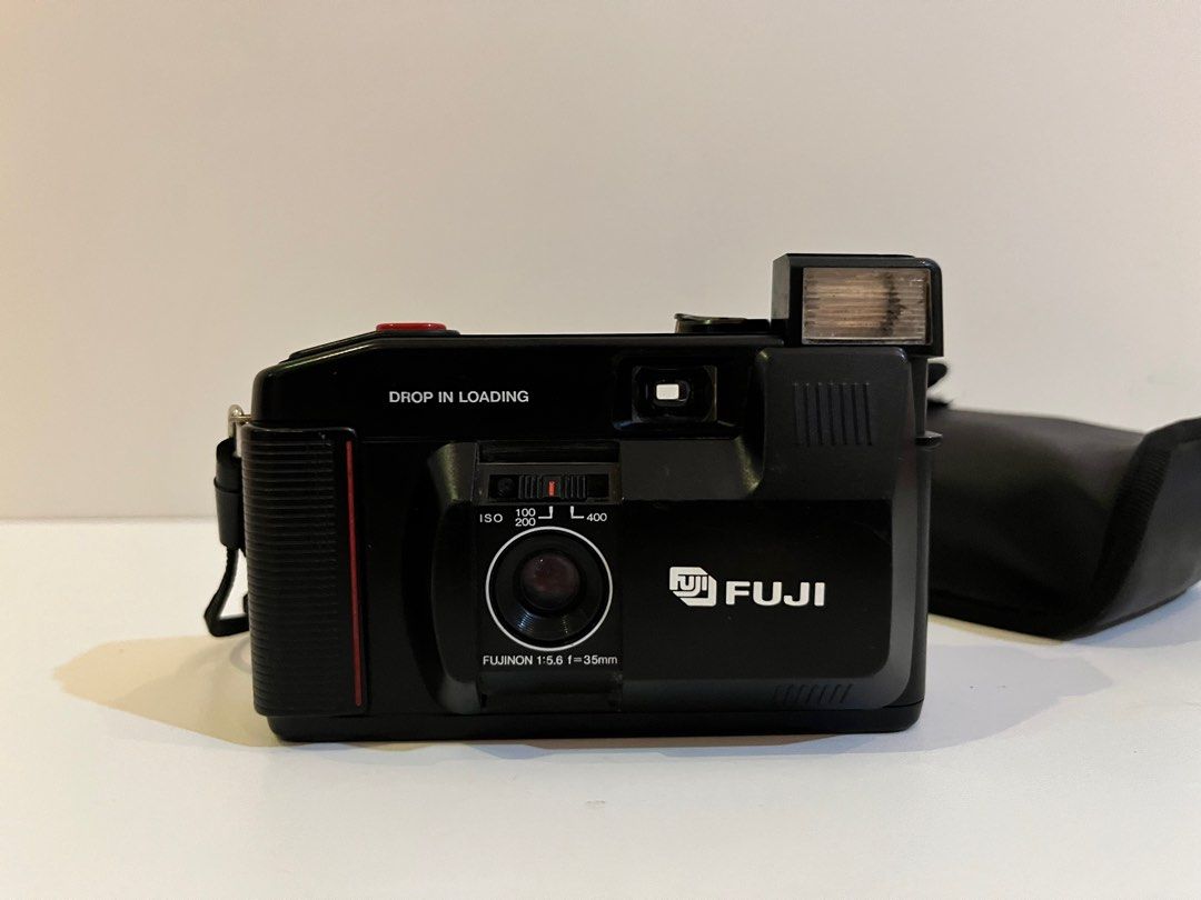 Fuji DL-10 Film Camera with Case (Category: Cameras) located in Legazpi City. Submitted by sunnisells (Listing ID 1416358101, Image 3). Description: Fuji DL-10 35mm point-and-shoot film camera - Fujinon 35mm lens - Built-in flash - Drop-in loading - Includes black carrying case - Comes with a strap - Features a red button and ISO dial - Requires batteries (as shown).
