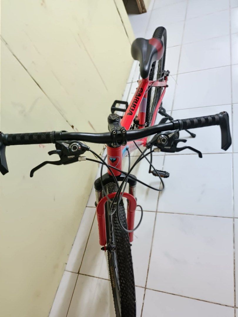 Garuda Mountain Bike (Category: Bicycles) located in Binan City. Submitted by mojicajemu98770 (Listing ID 1416373623, Image 3). Description: - Red Garuda mountain bike - Front suspension - Disc brakes - Kickstand - Black tires - Black seat with red accents - Red frame with black and blue accents - Gear shifters and brake levers rfs: wala na gumagamit can do meet up or pick up .