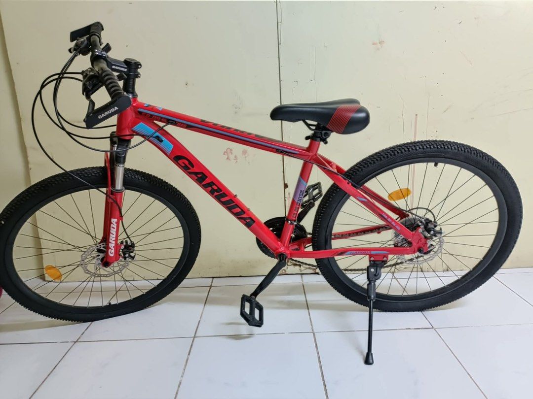 Garuda Mountain Bike (Category: Bicycles) located in Binan City. Submitted by mojicajemu98770 (Listing ID 1416373623, Image 1). Description: - Red Garuda mountain bike - Front suspension - Disc brakes - Kickstand - Black tires - Black seat with red accents - Red frame with black and blue accents - Gear shifters and brake levers rfs: wala na gumagamit can do meet up or pick up .