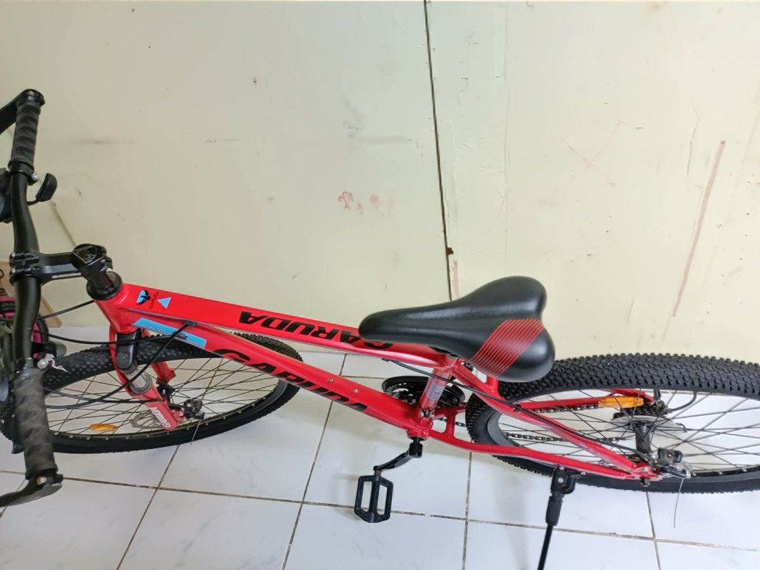 Garuda Mountain Bike (Category: Bicycles) located in Binan City. Submitted by mojicajemu98770 (Listing ID 1416373623, Image 2). Description: - Red Garuda mountain bike - Front suspension - Disc brakes - Kickstand - Black tires - Black seat with red accents - Red frame with black and blue accents - Gear shifters and brake levers rfs: wala na gumagamit can do meet up or pick up .