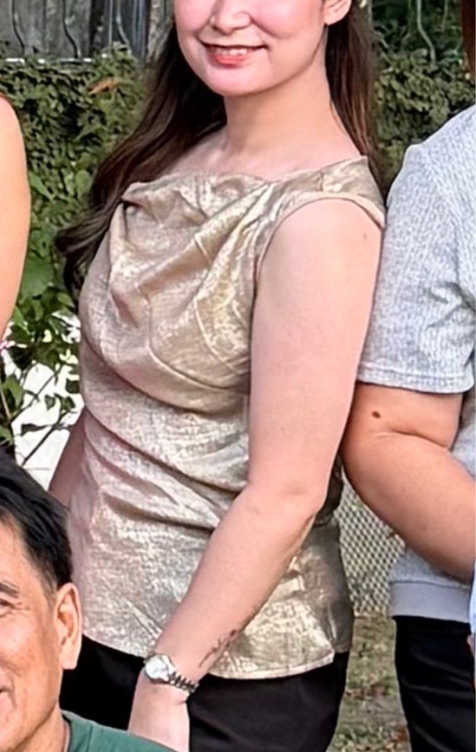 Gold One-Shoulder Top (Category: Sleeveless) located in Tanauan. Submitted by kdcstro (Listing ID 1416368677, Image 3). Description: - Worn once (christmas 2025) - Gold one-shoulder top - Draped design - Tie-back detail - Sleeveless - Asymmetrical neckline - Shimmering fabric - Ideal for special occasions.