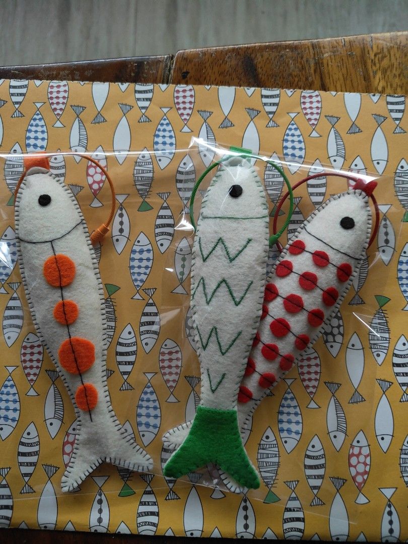 Handmade Felt Fish Bag Charm/ Keychain (Category: Plushies & Soft Toys) located in Mandaluyong City. Submitted by patchandpast (Listing ID 1416190010, Image 2). Description: Adorable handmade keychain/bag charm features a blue felt fish design. It has a white head and tail, with a blue body that has white cutouts. The keychain has a blue loop for easy attachment to keys or bags. It's a unique and charming accessory..