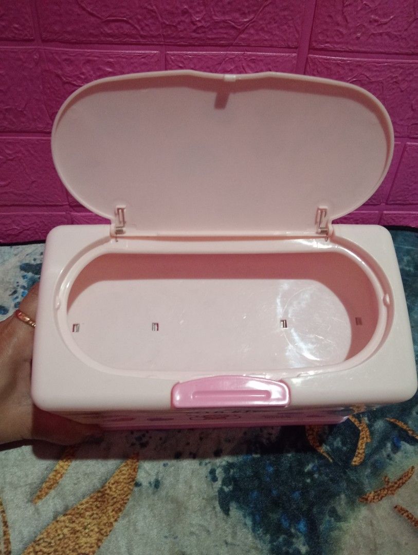 Hello Kitty Tissue Box (Category: Storage Boxes & Baskets) located in Bulacan. Submitted by renasophiatoystore2020 (Listing ID 1416344256, Image 3). Description: - Kitty tissue box - Pink and white design - Features Kitty graphics - Hinged lid for easy tissue access - Made of durable plastic - Rectangular shape - Branded "Skater" with Japanese text on the bottom.