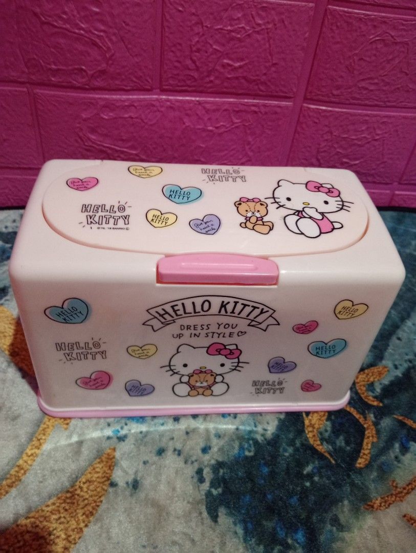 Hello Kitty Tissue Box (Category: Storage Boxes & Baskets) located in Bulacan. Submitted by renasophiatoystore2020 (Listing ID 1416344256, Image 2). Description: - Kitty tissue box - Pink and white design - Features Kitty graphics - Hinged lid for easy tissue access - Made of durable plastic - Rectangular shape - Branded "Skater" with Japanese text on the bottom.