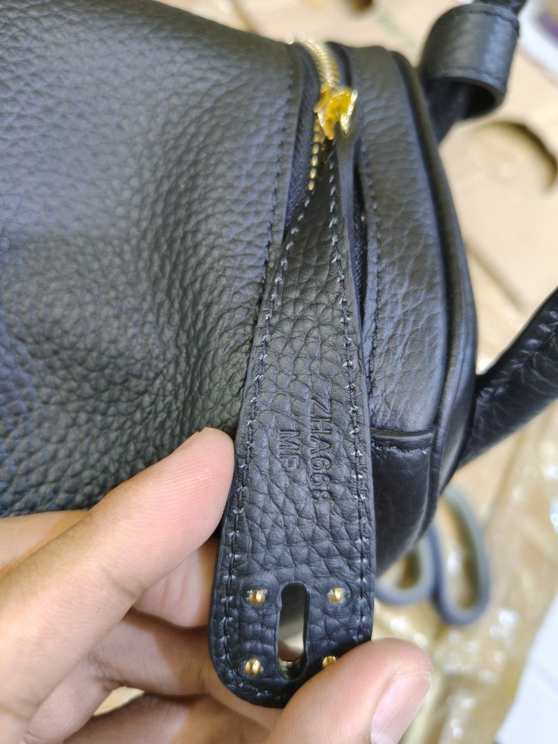 Hermes Lindy Bag Black (Category: Luxury Bags & Wallets) located in Davao. Submitted by navil01 (Listing ID 1416314078, Image 2). Description: - Hermes Lindy Bag - Color: Black - Hardware: Gold-tone - Interior: Black leather lining - Exterior: Pebbled leather - Includes: Shoulder strap - Additional: Protective feet - Origin: Made in France.